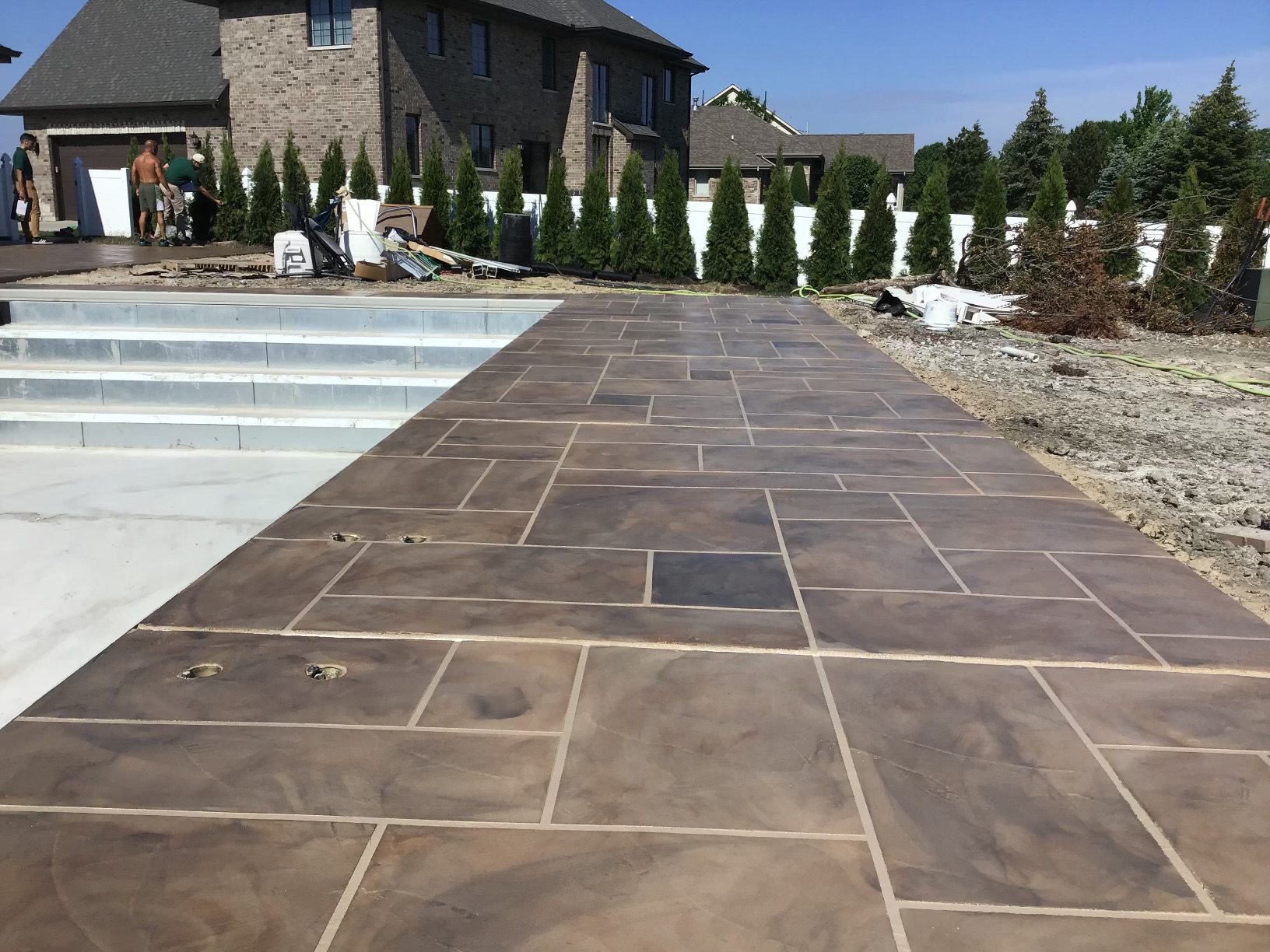 Custom poolside paver installation at a luxury home